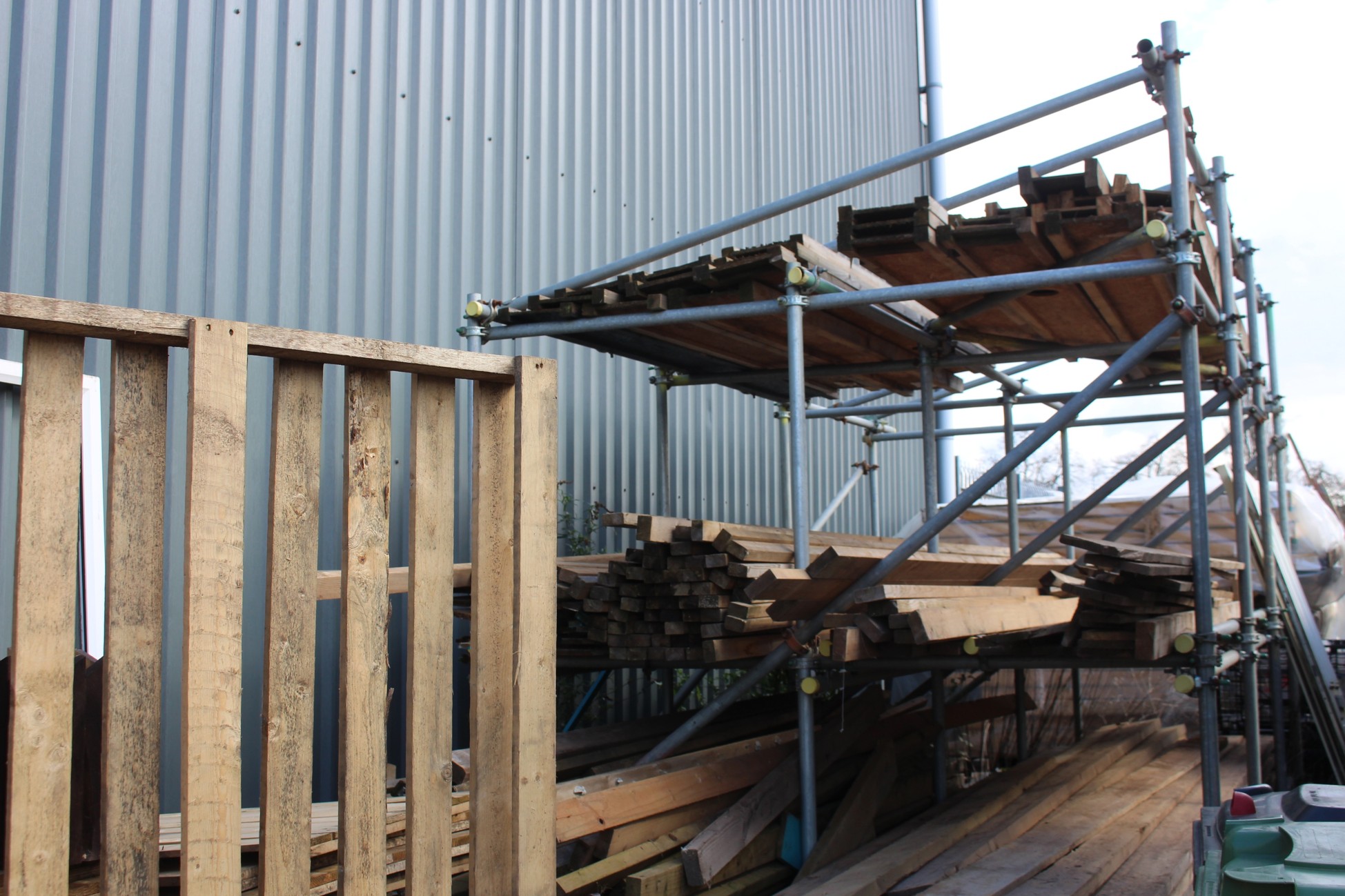 Rack with long lengths of reclaimed wood on it